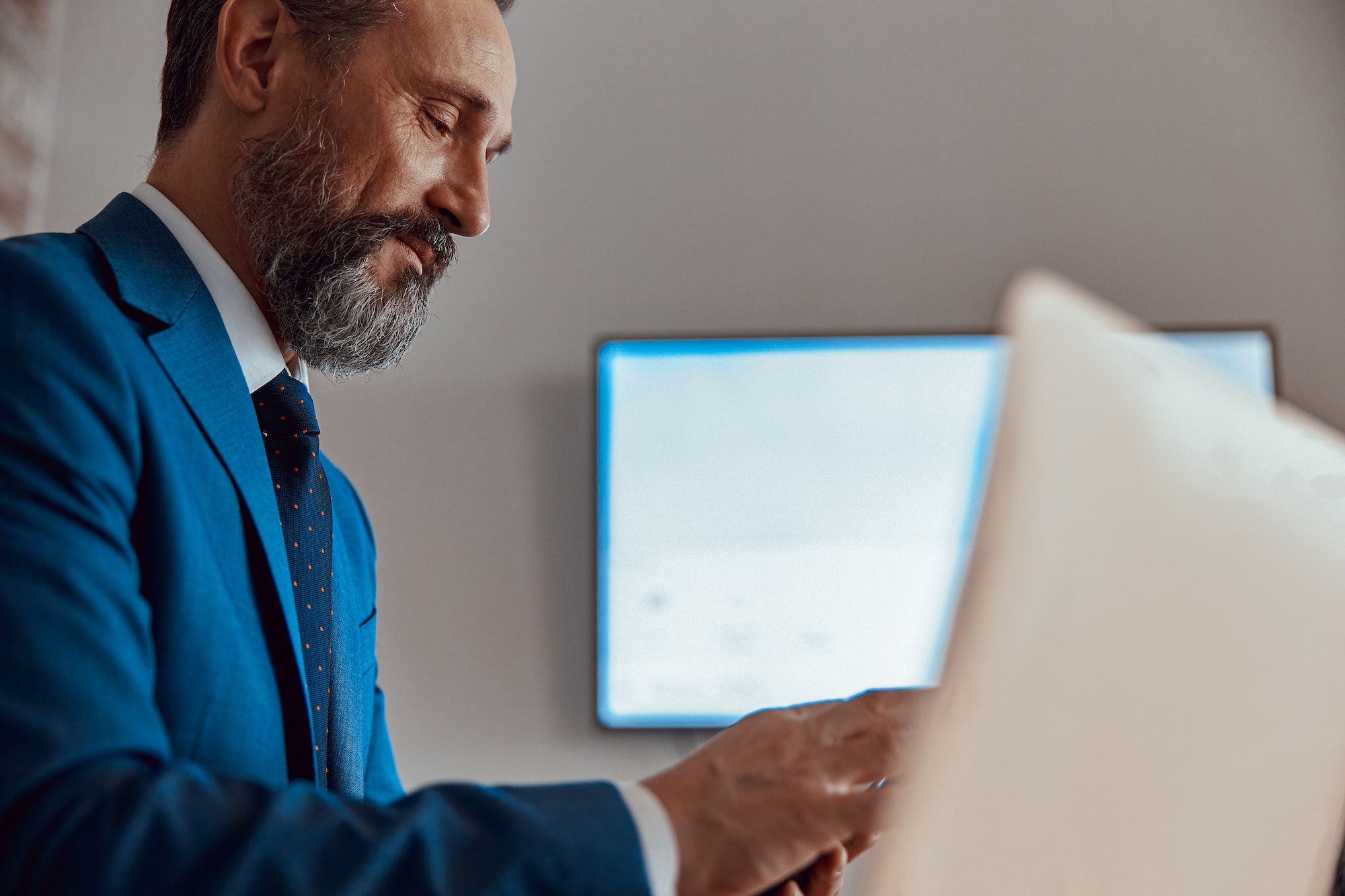 Adult businessman working at with laptop on desk