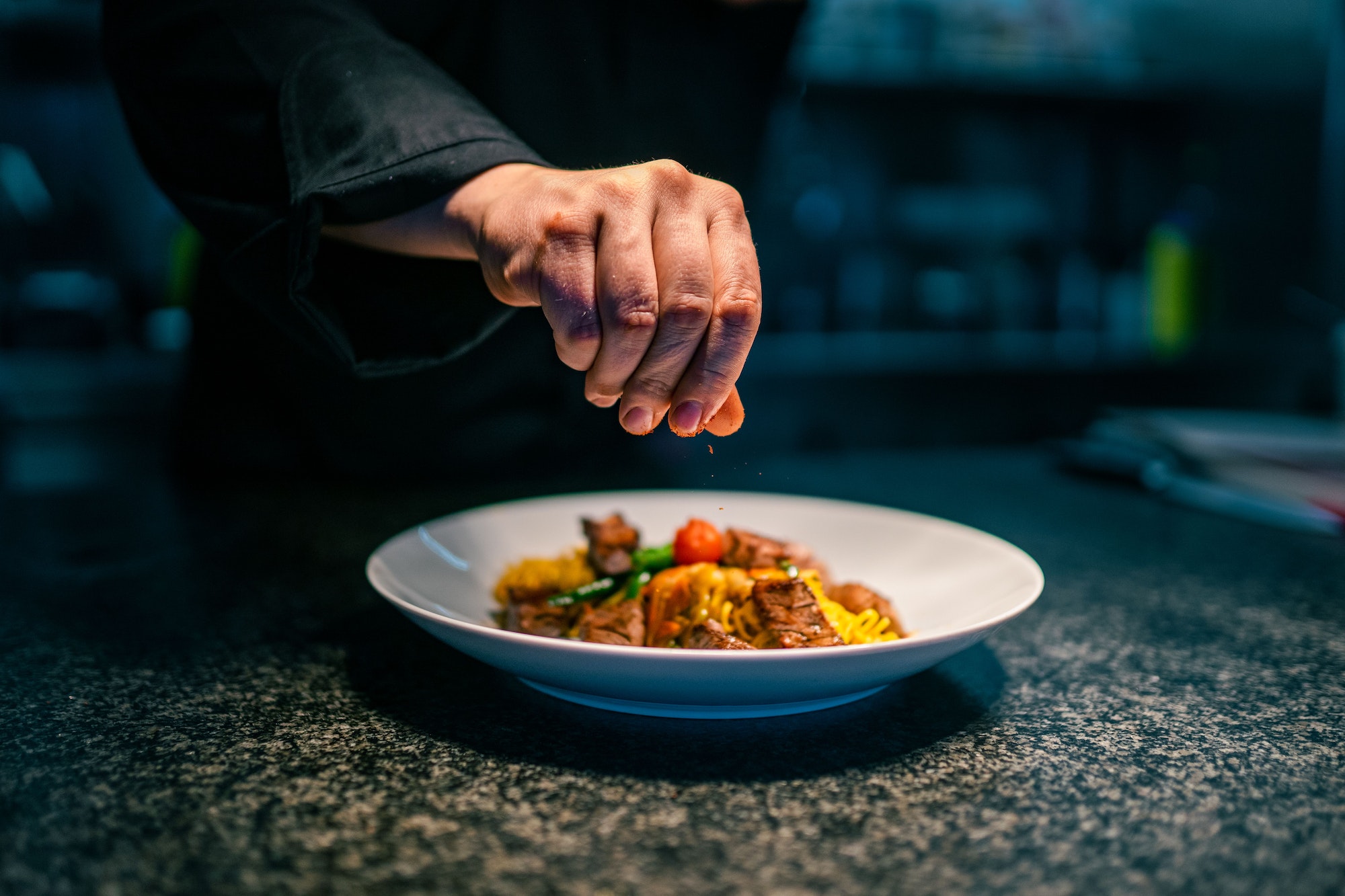 Closeup shot of a chef's hand while preparing the food