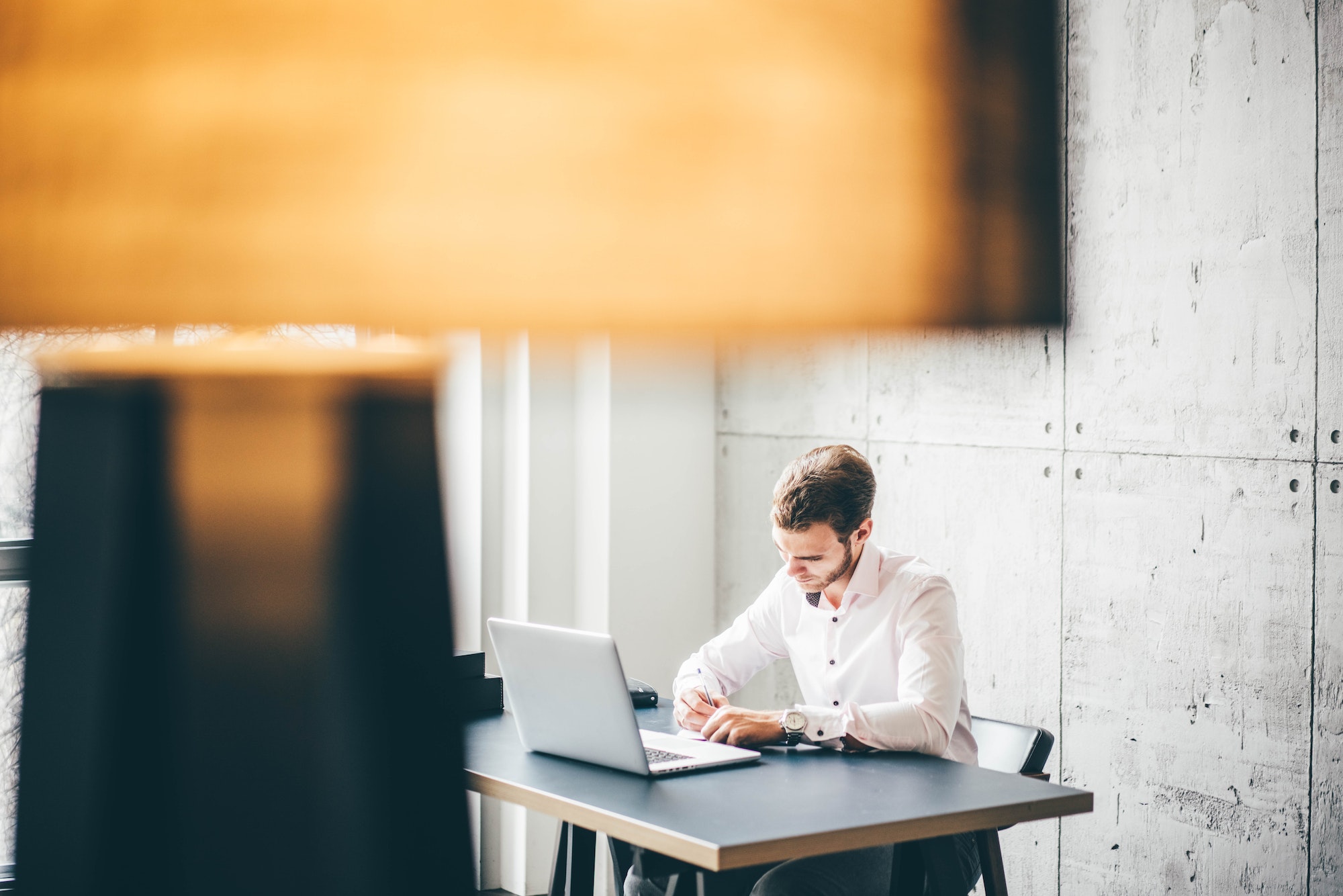 Business man working at office with laptop and documents on his desk.