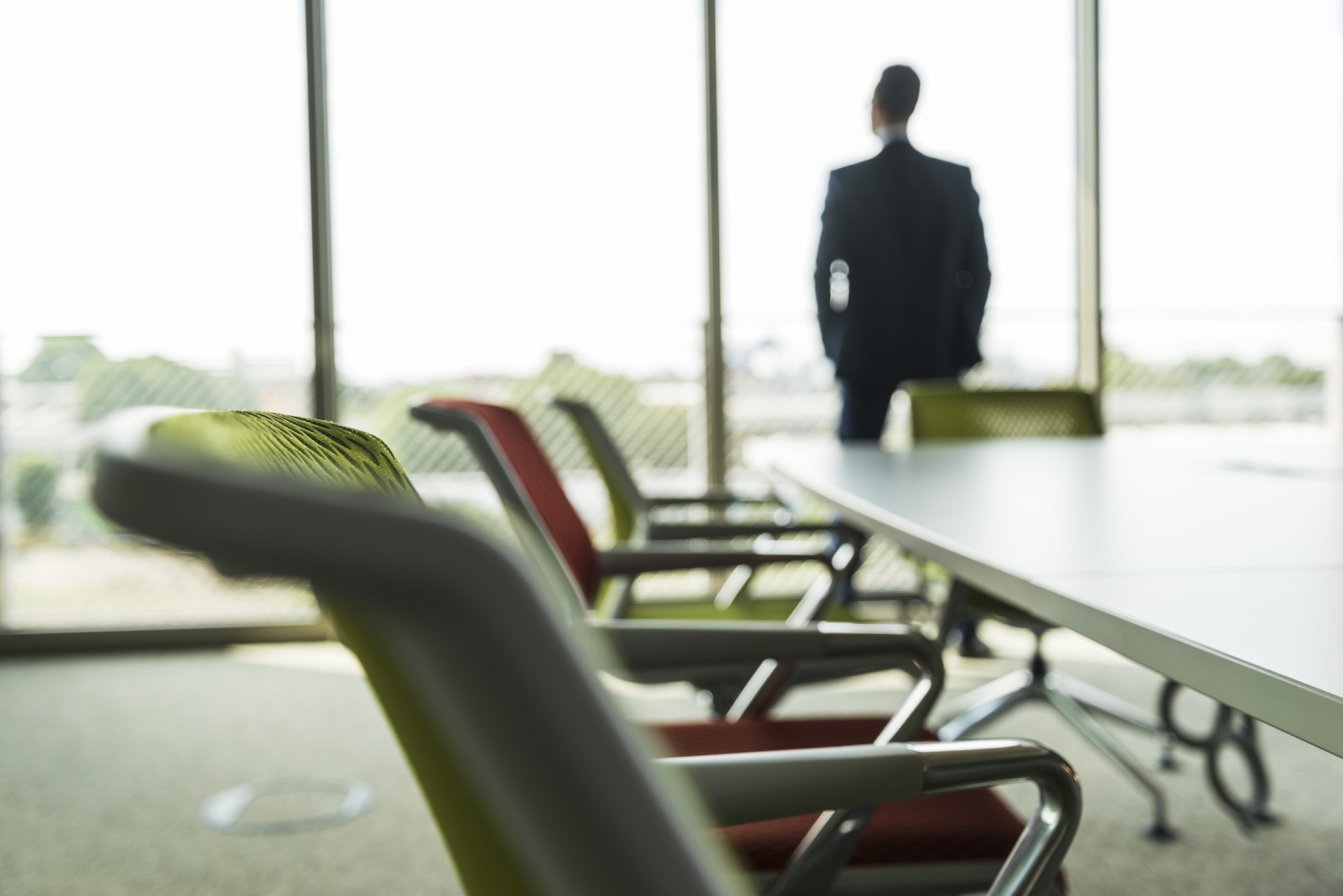 Conference room with businessman at the window