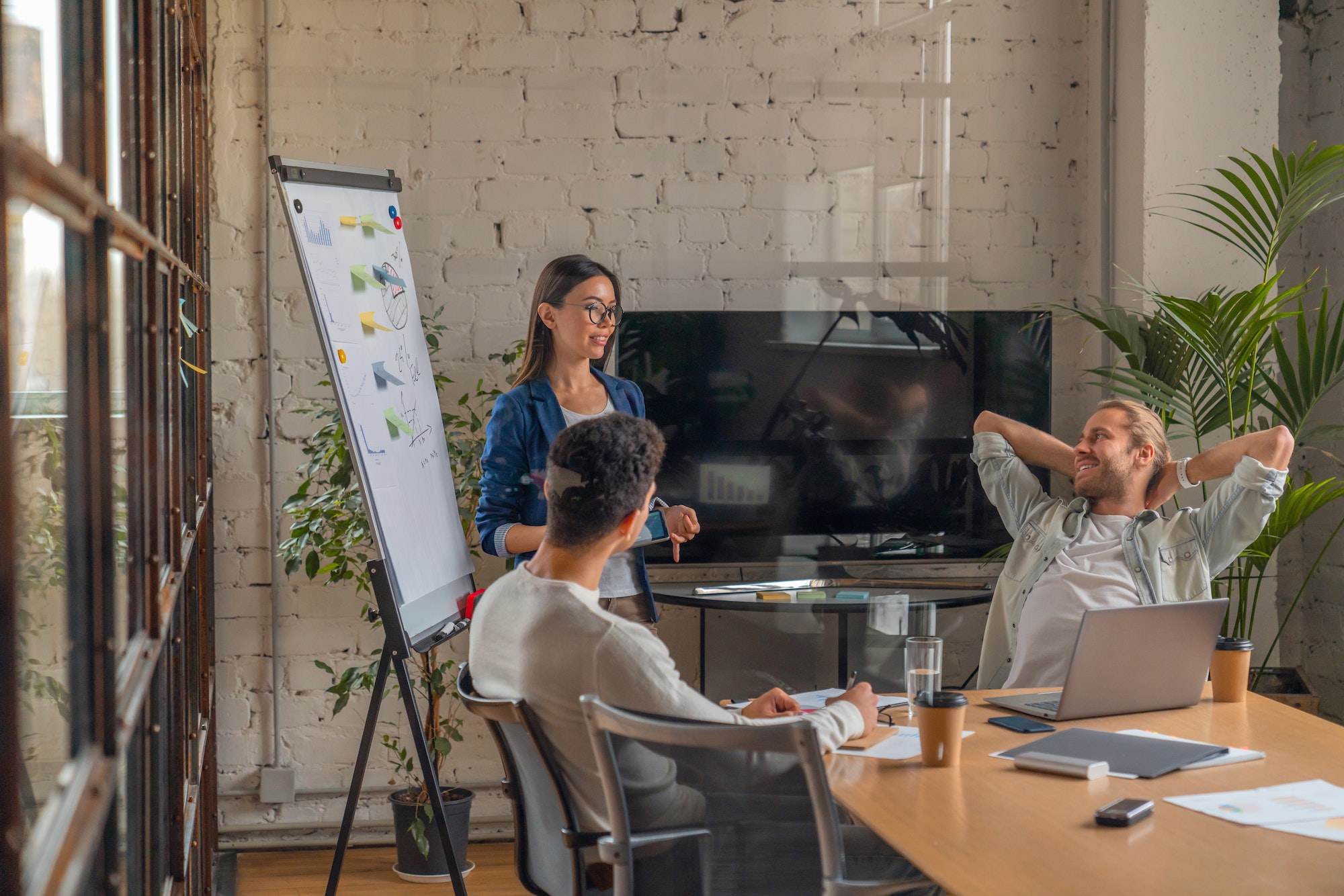 Indoor shot of creative team discussing ideas in business meeting.